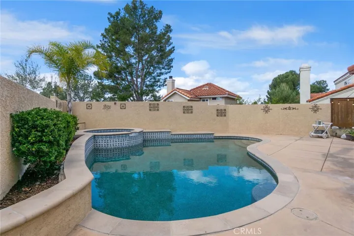 Pool and spa area tucked in the corner of spacious back yard.