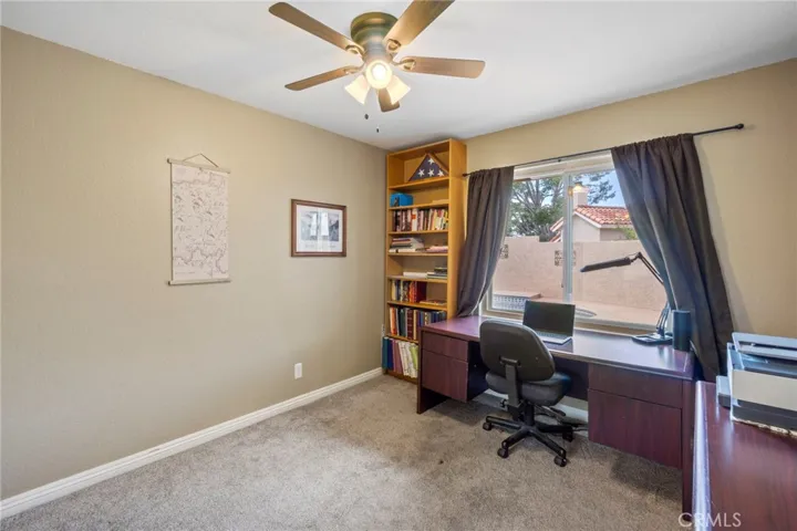 Downstairs bedroom or office overlooking the pool area.
