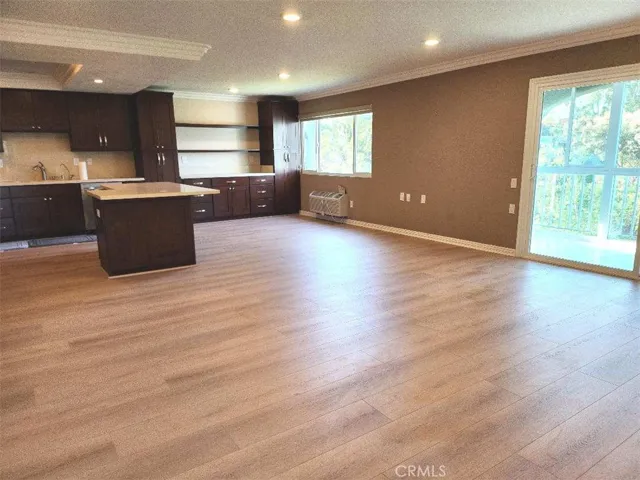 Livingroom sliding door accessing glass enclosed balcony.