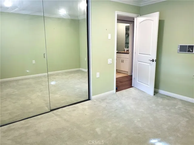 2nd bedroom showing the hallway to guest bathroom.