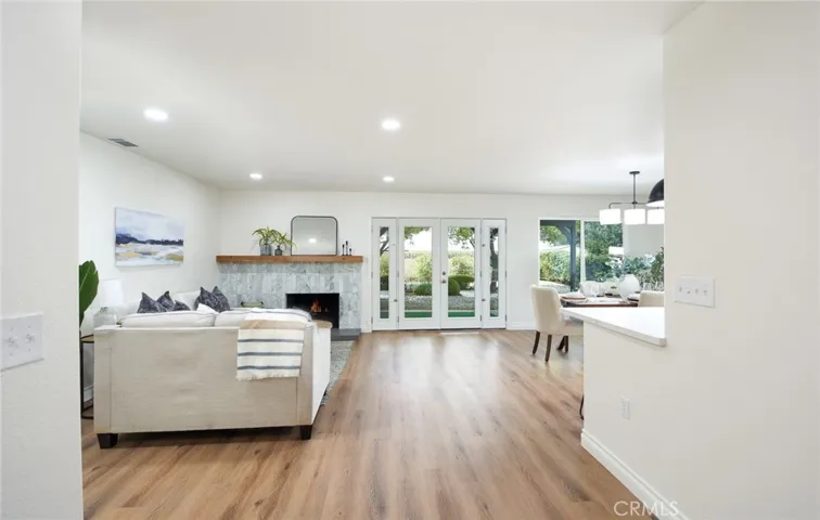 Through the front door, you enter into a spacious family room. Bright and open, the entire house has been freshly painted and has new flooring throughout. Backyard patio is just through these new french doors. Check out the french door side, ventilation doors!