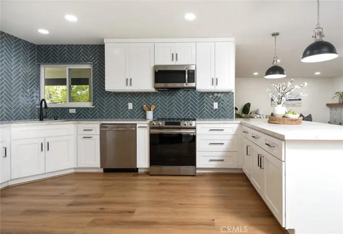 Fully renovated kitchen with new cabinetry, appliances, and quartz countertops