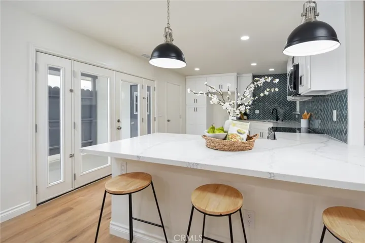 Side patio is located just off the kitchen through the brand new, french doors.