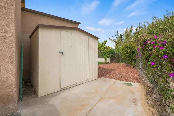The shed/storage room is located at the very back of the long driveway.