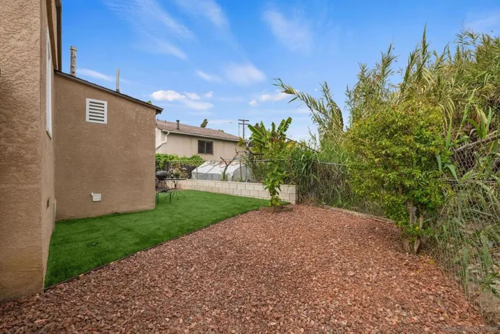 The backyard circles around to the long driveway that can be entered from the front street or from the backyard.