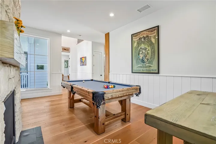 Game room with fireplace. Would also make a lovely den.