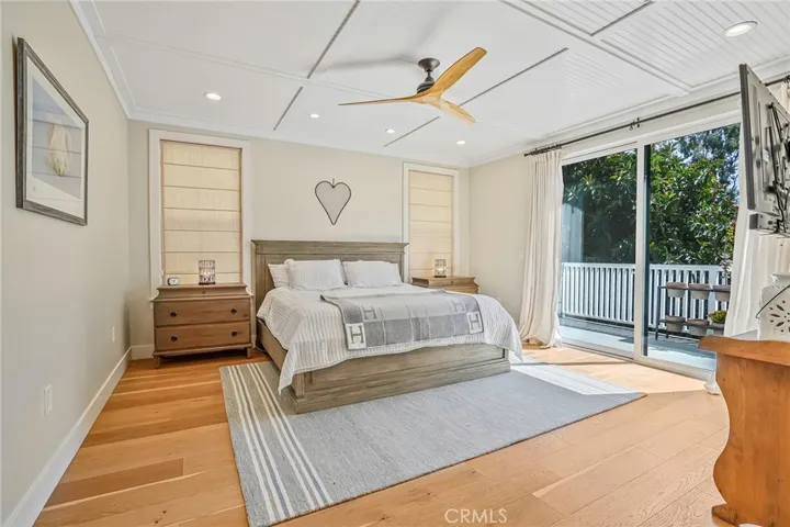 Primary bedroom with large patio facing backyard and large attached primary bathroom.