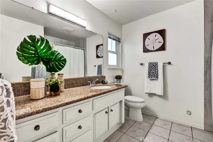 Hallway Bathroom has Tub/Shower Combo, Upgraded with Designer Tile Surround. It Also has Tile Flooring and Granite Countertops