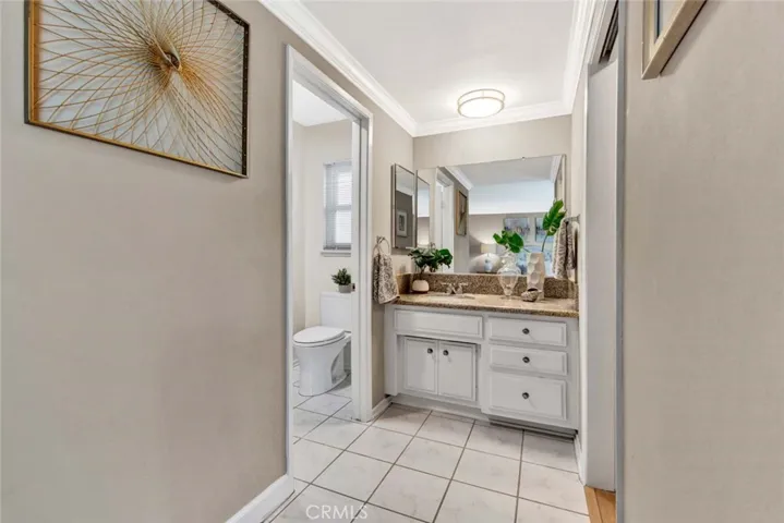Primary Suite Bathroom with Tile Flooring, Granite Countertop, Dressing Area, Walk-In Closet, Shower