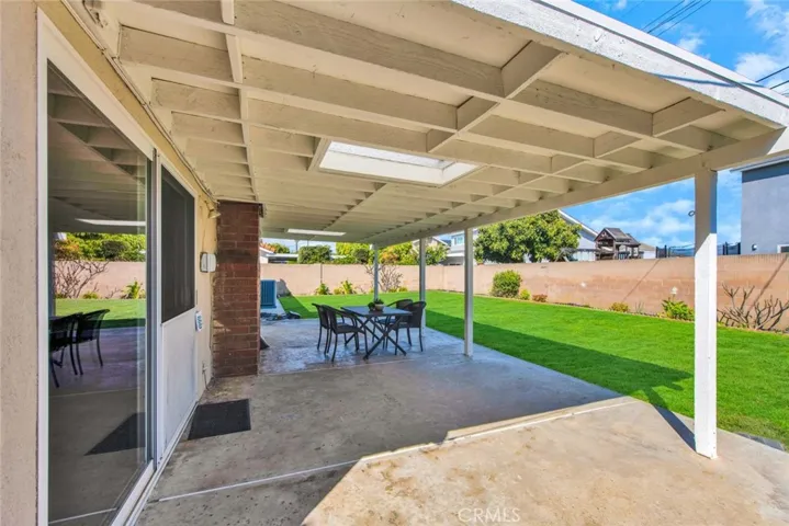 Beautiful Park-Like Backyard with Covered Patio that has a Skylight