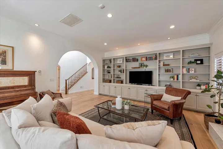 Spacious living room with built-in bookcase/entertainment center.