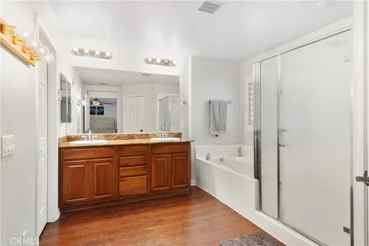 Primary en suite bathroom with seperate tub, shower and double sinks