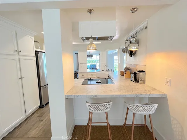 Family room connected to kitchen with counter seating.