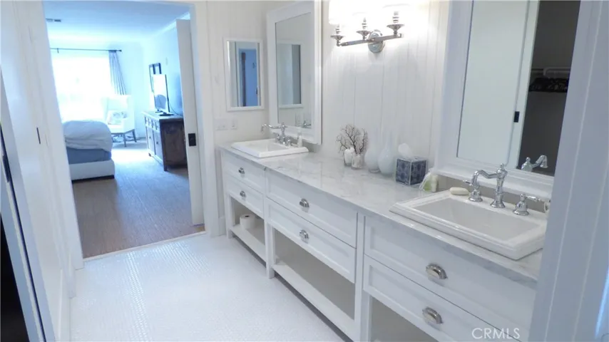 Primary en-suite bathroom with double sink vanity.