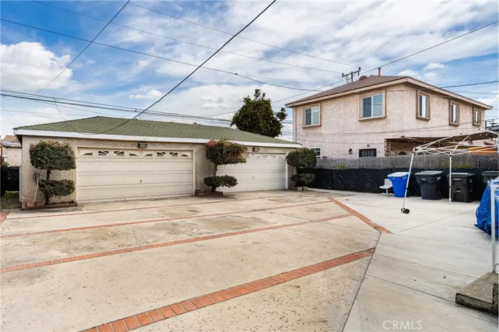 Two separate two car garages. one of these has a bathroom and a pedestrian door.