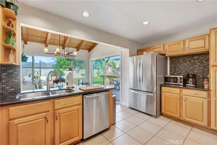 Stainless steel appliances.  Kitchen looks into open room leading out to back patio.  Perfect for entertaining