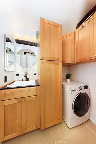 Updated vanity with designer lighting, laundry area with Alll-In-One LG washer/dryer machine, and plenty of extra cabinet storage.