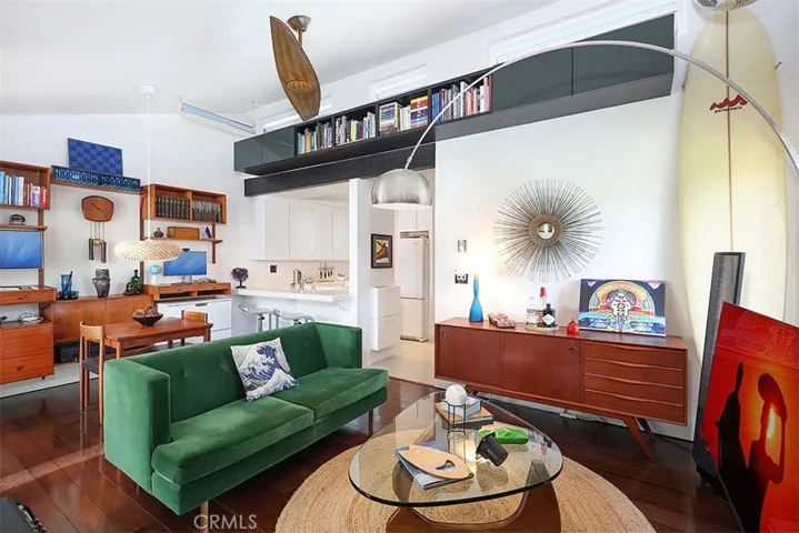 Listen to the ocean waves in the living room with Remote Control Awning Windows and custom bookcase.