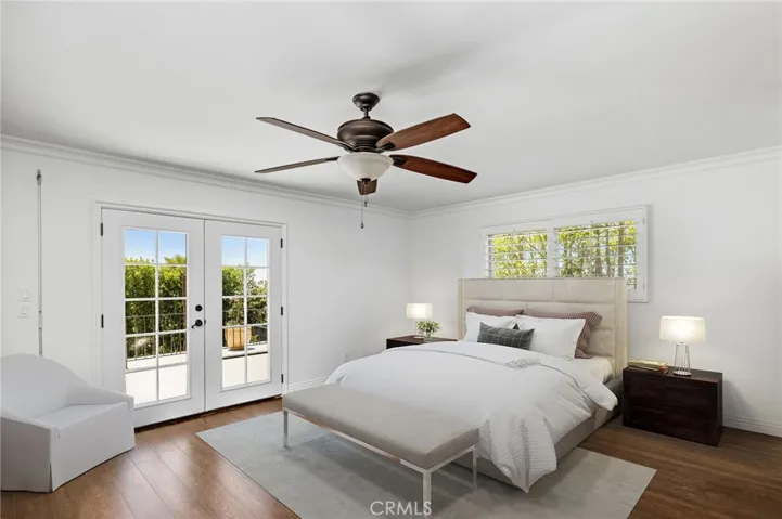 Primary bedroom features direct access to large deck with ocean views. Photo has been virtually staged.
