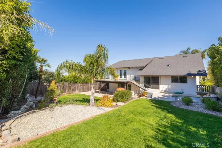 Large, flat, private backyard has room for a pool.