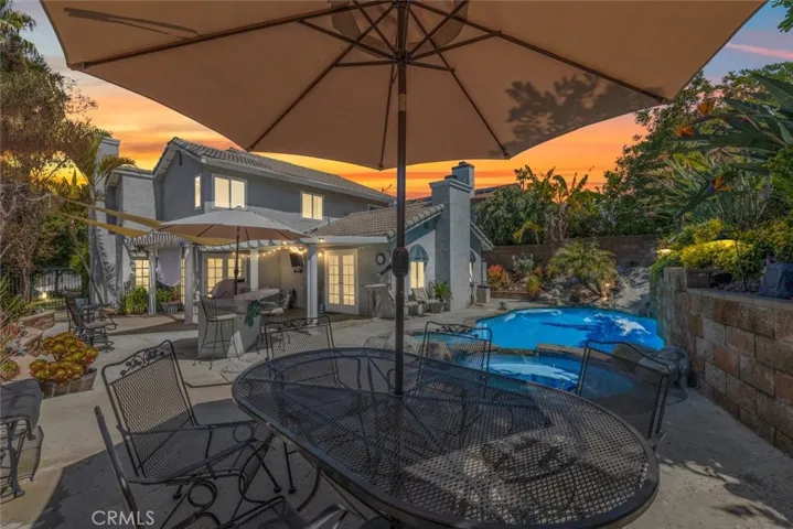 Relax in this tranquil backyard oasis, featuring a sparkling pool and spa nestled amongst lush landscaping, complemented by a spacious patio with comfortable seating under an expansive umbrella, all set against a stunning sunset sky.





Relax in this tranquil backyard oasis, featuring a sparkling pool and spa nestled amongst lush landscaping, complemented by a spacious patio with comfortable seating under an expansive umbrella, all set against a stunning sunset sky.







Relax in this tra