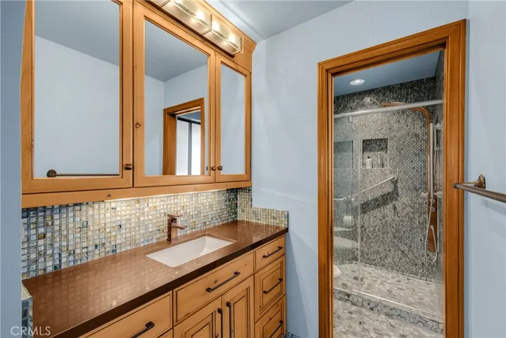 Remodeled Primary Bathroom Vanity with Glass Mosaic tiles