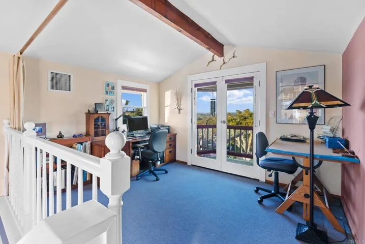 The 2nd story of this space has 2 separate rooms. This room has a balcony overlooking the backyard.
