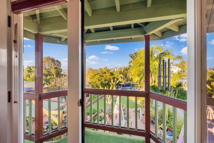 A covered balcony off of one of the upstairs rms. It overlooks the beautiful, backyard of this home.