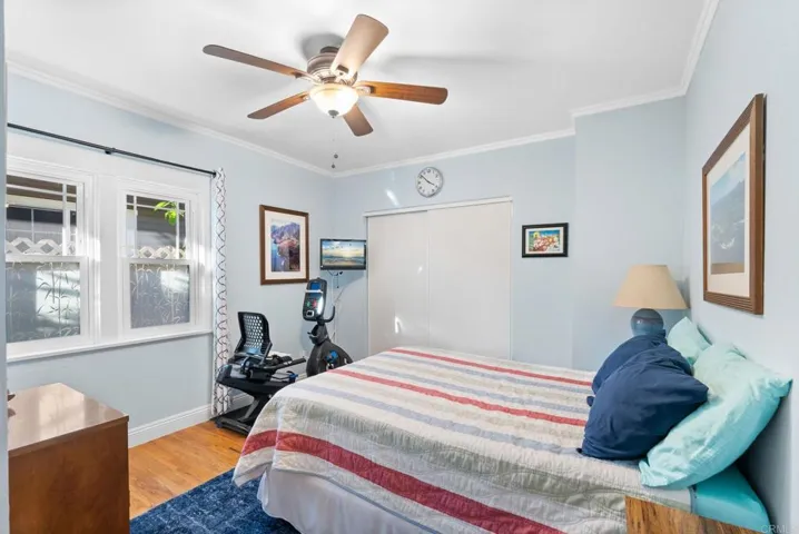Upper and lower molding, ceiling fan and the wood flooring puts it above the average 2nd bedroom.