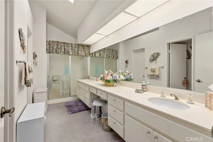Master Bathroom with dual sinks and step in shower - large walk-in closet to the left