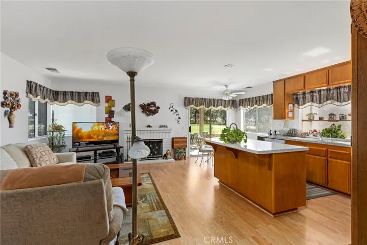 Family Room, Gas Fireplace, and kitchen and slider to patio overlooking the views of the golf course and mountains