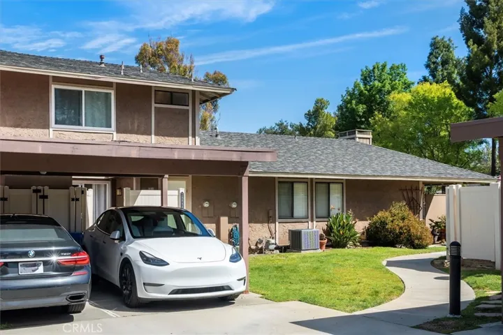One carport space that is close enough to the door that you can use the laundry 220V to charge your car!