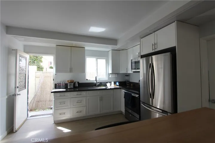 Unit C- Kitchen. Back door allows cross ventilation and easy access to double garage.