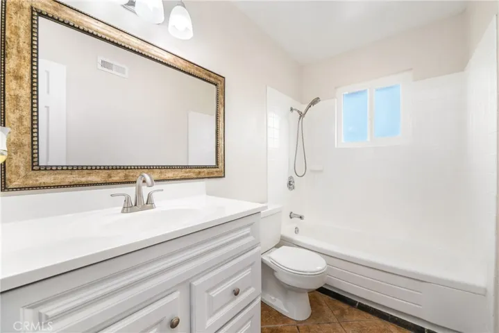 Pleasant touches continue upstairs with an updated hallway bathroom
