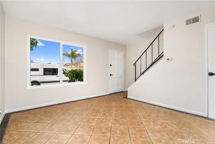 Entering the home, you are greeted by a bright and spacious family/dining room with tile floors