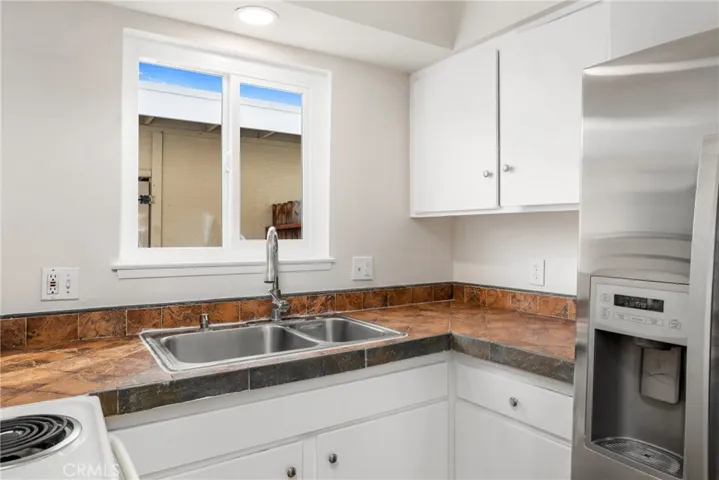 The well-appointed kitchen provides the perfect setting for cooking family meals or hosting intimate dinner parties with friends
