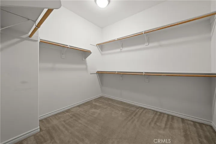 Walk-in closet in primary bedroom