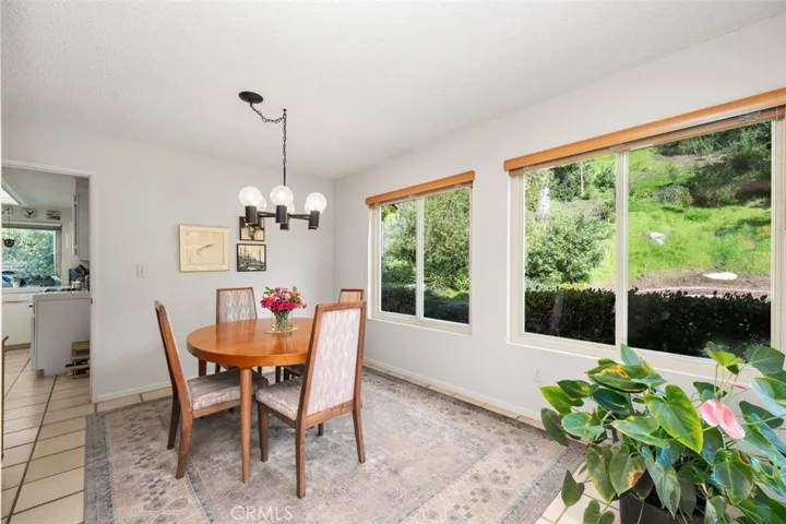 Dining room with lots of light and green belt view windows