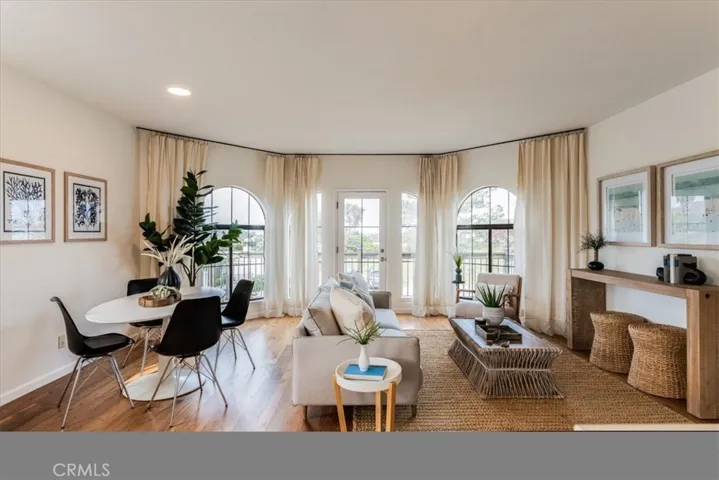 Large windows and door to front deck flood the space with light.