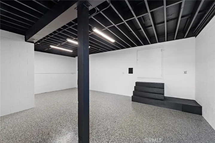 Bonus space beneath the garage. Can be used as an ADU, office, gym, storage, etc. New epoxied floors.