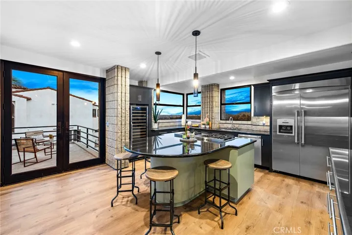 kitchen with Thermador gas range and full height wine fridge
