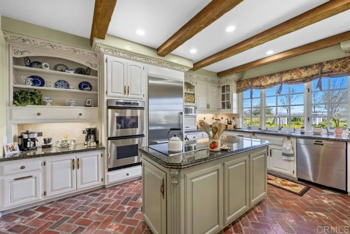 Kitchen with new Miele Refrigerator, upgraded stainless appliances, stainless sink and views!