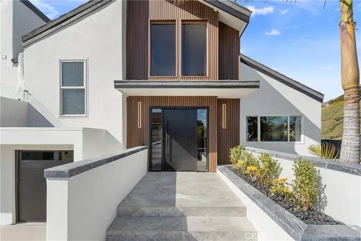 Entryway with stone flooring and wall cladding
