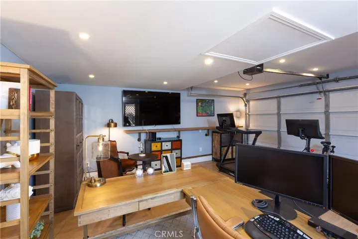 The garage is completely redone, with flooring, an HVAC system, drywalled, and canned lights.