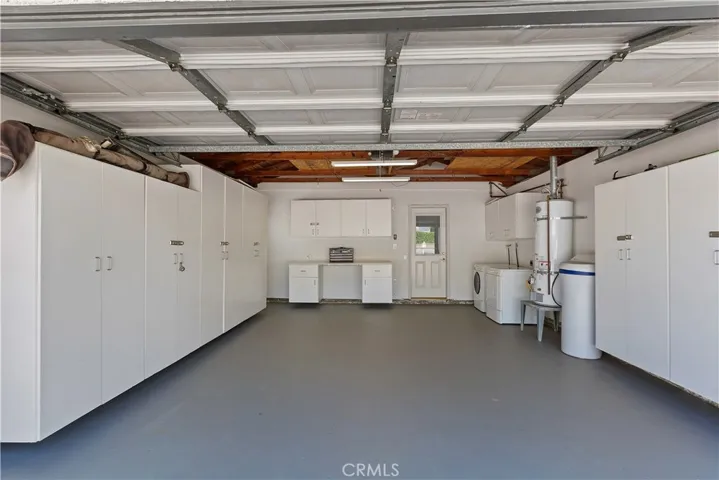 Welcome to automotive paradise! Step into this impeccably clean garage, meticulously designed for the ultimate enthusiast. With its gleaming painted floor and pristine surroundings, this space sets the stage for automotive excellence.