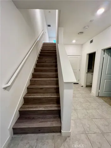 Entry area to 1 bedroom, 1 bath, garage and stairs to 2nd floor