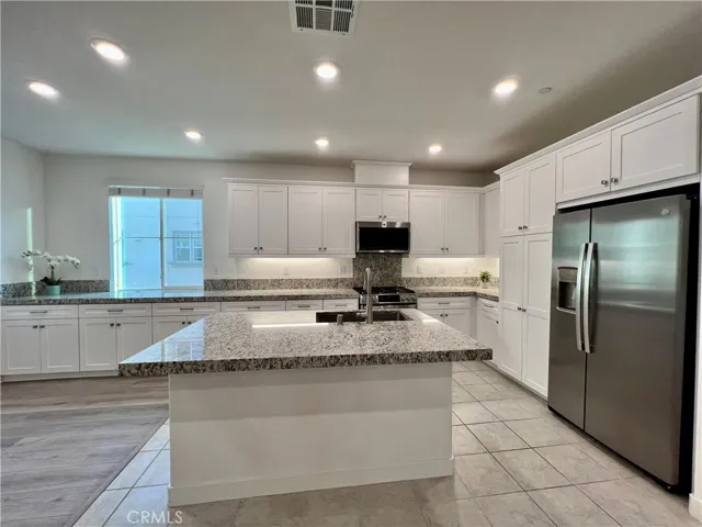 Kitchen with refrigerator and lots of cabinets