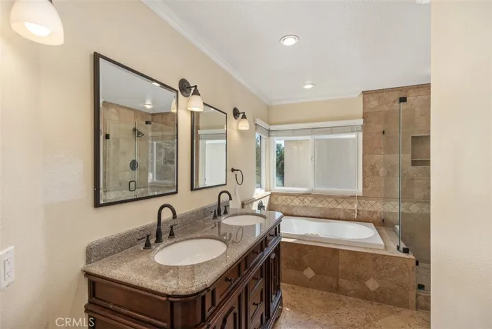Discover the spa inspired En-suite with dual vanity, oversized, separate bathtub, and relaxing frameless shower