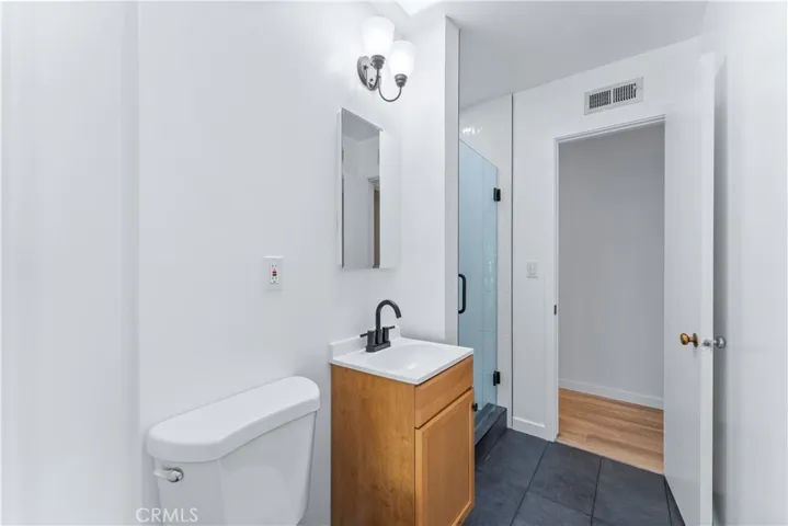 This bathroom has access to the back room / primary.