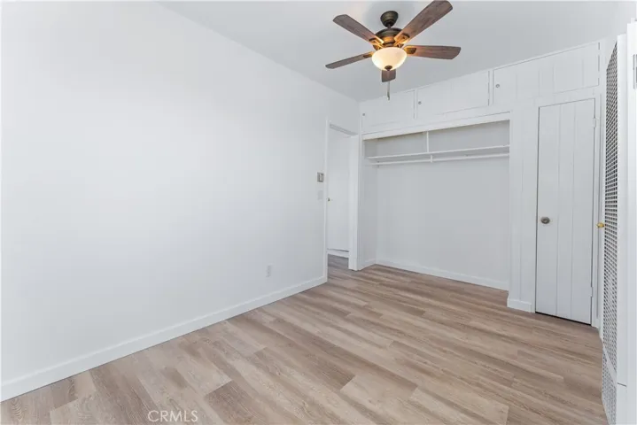 This has access to the back room which is staged as a primary bedroom. Great as a walk-in closet for the primary bedroom.